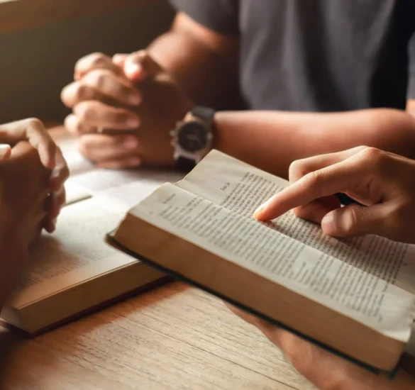 young man reading bible with friends who are praying to God Join the cell group at the church. A small group of Christians or concepts in a church at a church.